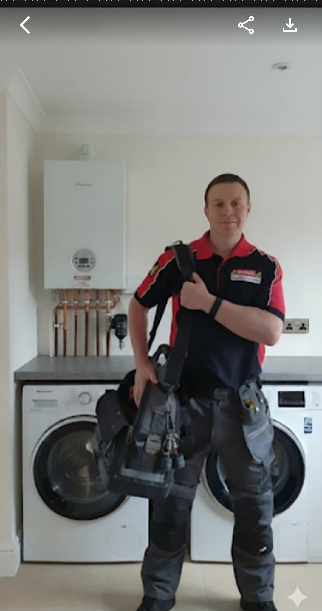 "Daniel from Absolute Plumbing & Heating, local Gas Safe boiler engineer in Crowborough, standing in front of a newly installed Worcester Bosch boiler ready for servicing and repairs."