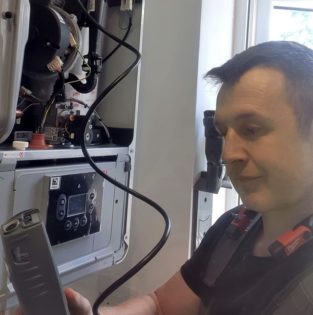 Daniel from Absolute Plumbing & Heating carrying out boiler testing during a service visit in Crowborough