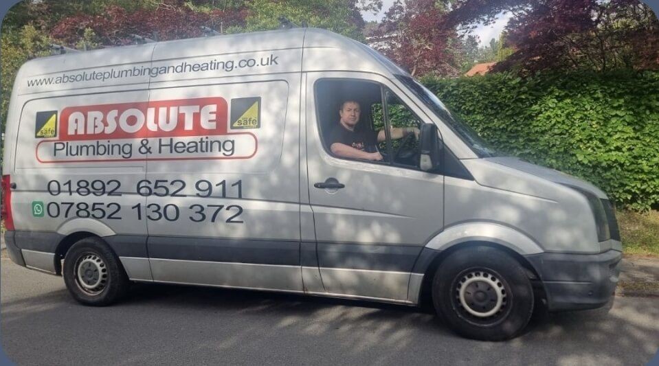 Absolute Plumbing and Heating van parked in Tunbridge Wells with company branding and contact details visible