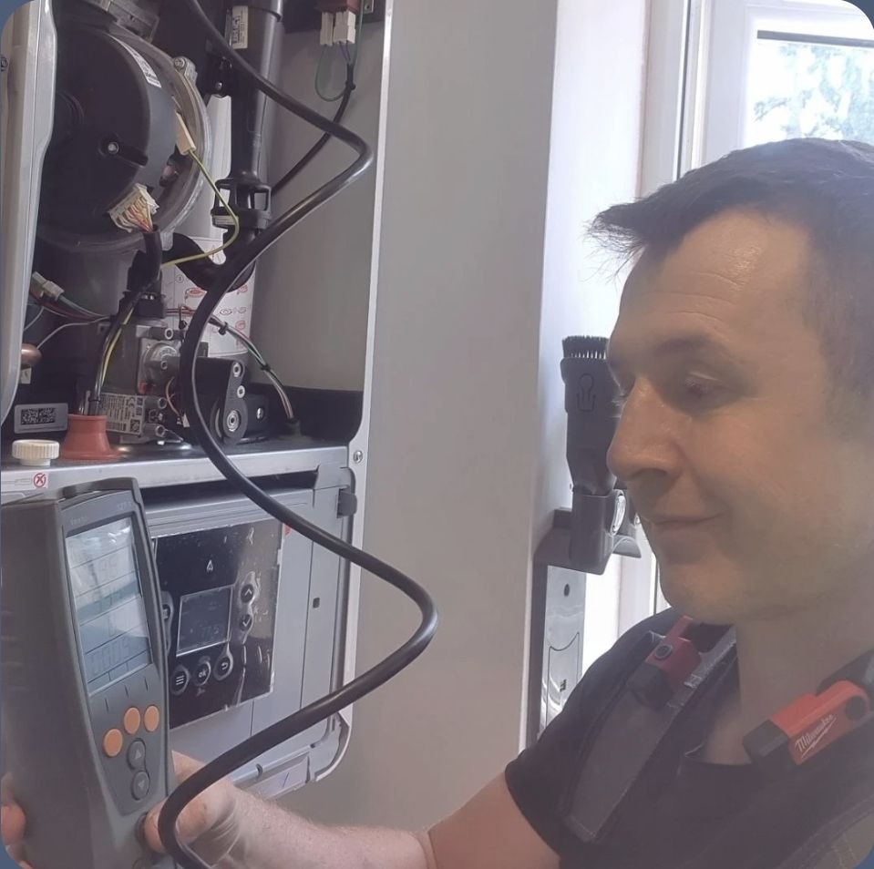 Gas Safe engineer carrying out a full boiler service using a flue gas analyser to check safety and efficiency