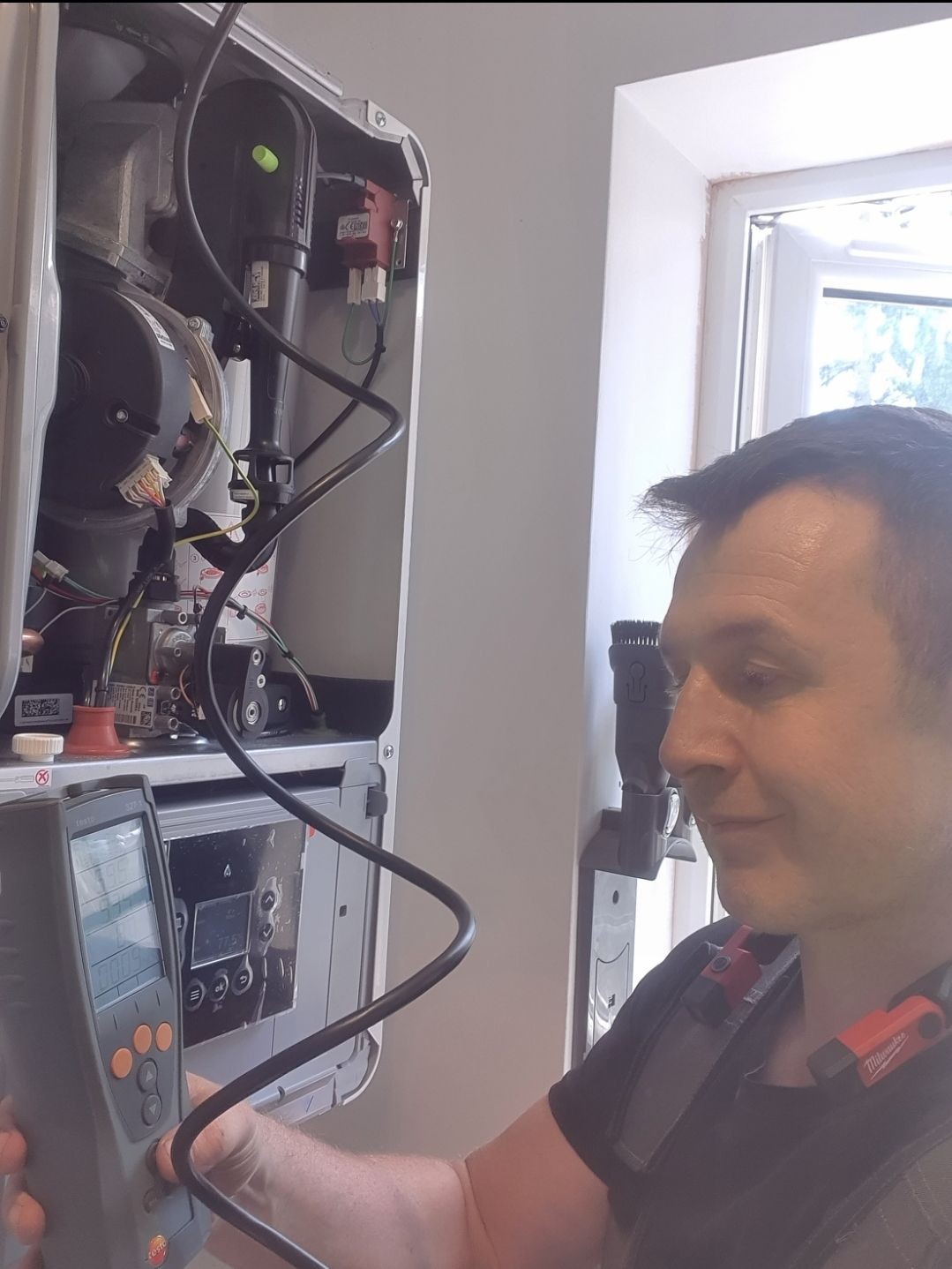 Daniel performing a boiler service inspection inside a customer’s home in Crowborough.  Let me know if you want to mention Cristina, the boiler brand, or change the location for other pages.