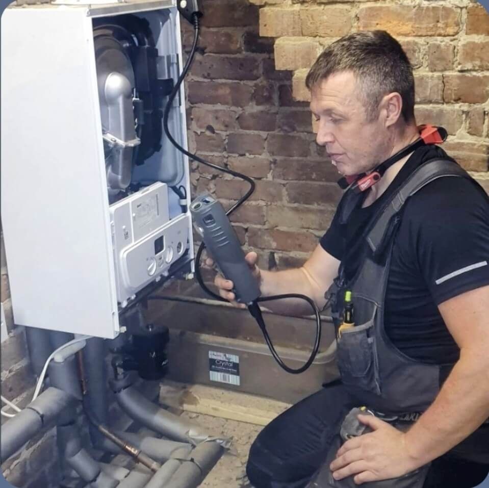 Daniel carrying out a flue gas analysis during a boiler service in Uckfield, ensuring safe and efficient heating system performance.