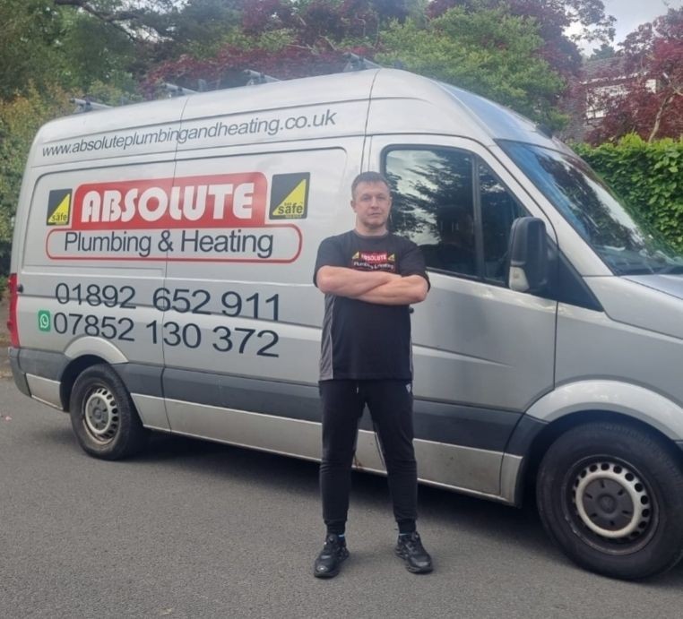 Gas Safe engineer standing in front of Absolute Plumbing & Heating van, ready for a professional boiler installation.
