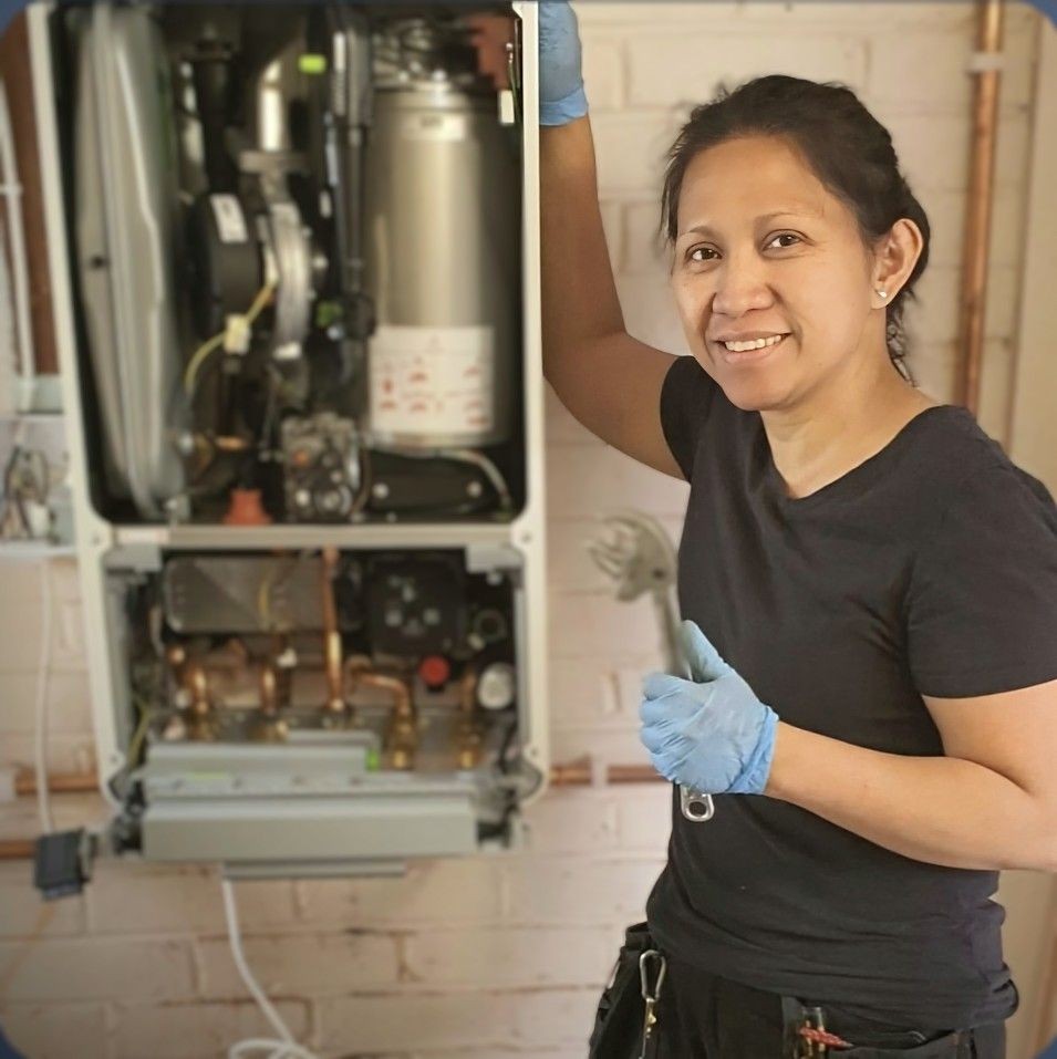 Cristina from Absolute Plumbing & Heating servicing a combi boiler in Crowborough – trusted local heating engineer.